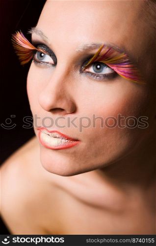 Glamour portrait of young fashion model with face art