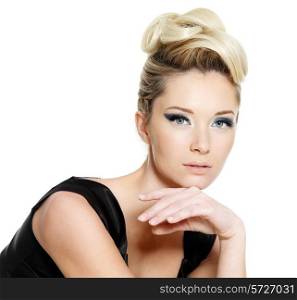 Glamour young woman with blue eye make-up and curly hairstyle on white background