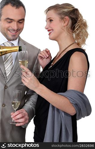 Glamourous couple drinking champagne