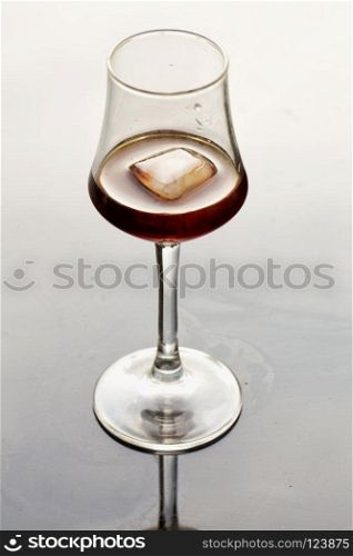 Glas with liquor and ice, vertical image