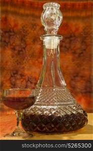 Glass and bottle of brandy with orange gradient background