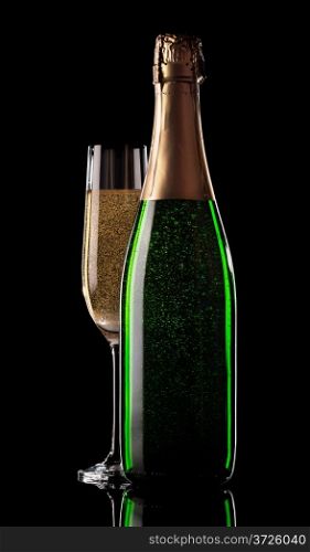 Glass and bottle of champagne on a black background