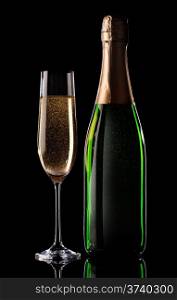 Glass and bottle of champagne on black background