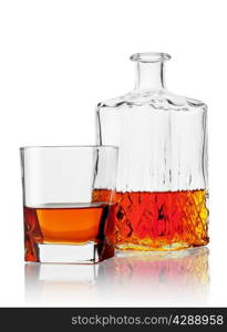 Glass and carafe of cognac isolated on white background