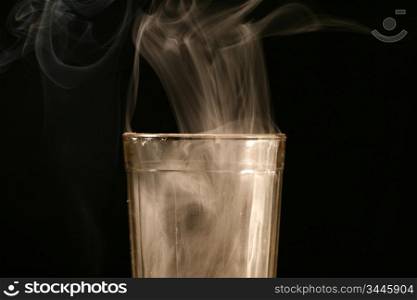 glass and smoke on black background