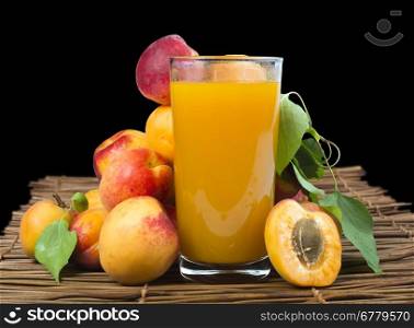 Glass apricot juice and apricot fruit. Black isolated Studio shot