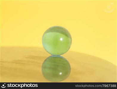 glass ball on yellow background