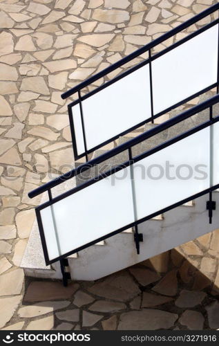 glass banisters stairway with masonry floor background