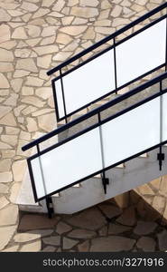 glass banisters stairway with masonry floor background