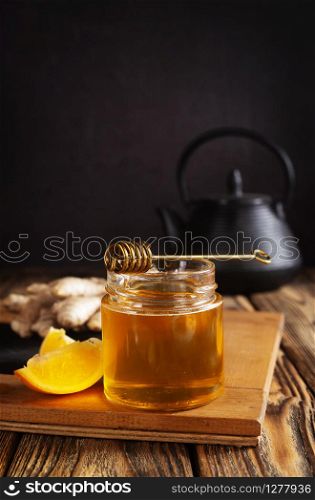 Glass bank with honey ginger lemon and cinnamon.