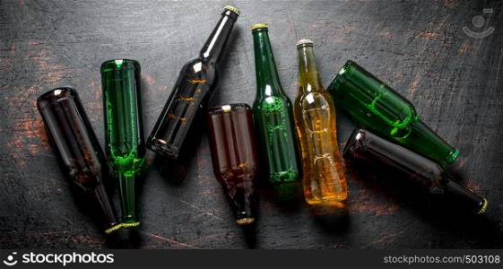 Glass beer bottles. On dark rustic background. Glass beer bottles.