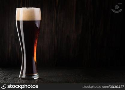Glass beer on wood background. Glass beer on wood background with copyspace