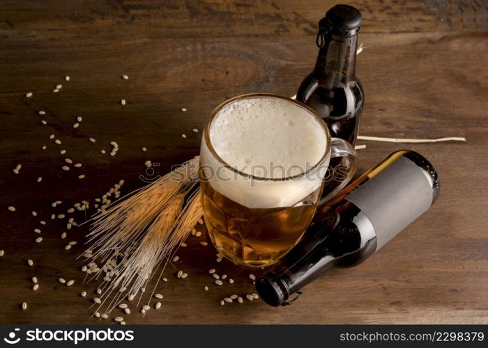 glass beer with brown bottles beer wooden table