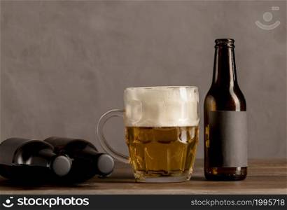 glass beer with foam brown bottles beer wooden table