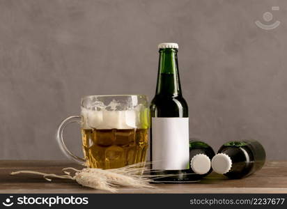 glass beer with foam green bottles beer wooden table