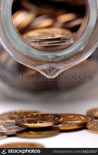 Glass bottle full of coins. Glass bottle full of coins on a white background