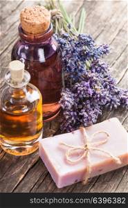 Glass bottle of essential oil and dry lavender bunch. Spa concept. The essential oil