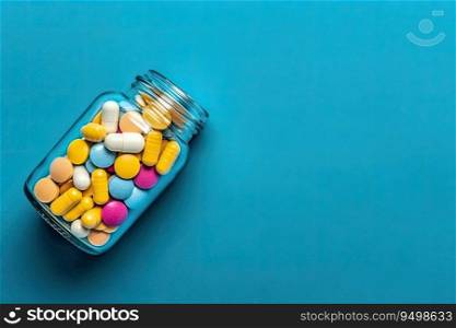 Glass Bottle of Pills is surrounded by a pile of colorful pills