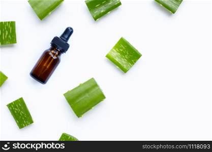 Glass bottle of products for spa or skin care cosmetic with aloe vera leaves cut pieces isolated on white background. Copy space