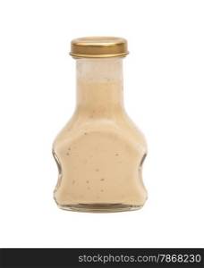 Glass bottle of white sauce. Isolated on white background