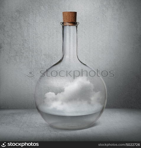 Glass bottle with liquid and vapor standing inside gray box