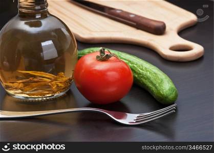 glass bottle with spices and vegetables on a cutting board