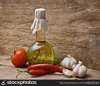 glass bottle with spices and vegetables on a cutting board