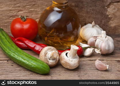 glass bottle with spices and vegetables on a cutting board