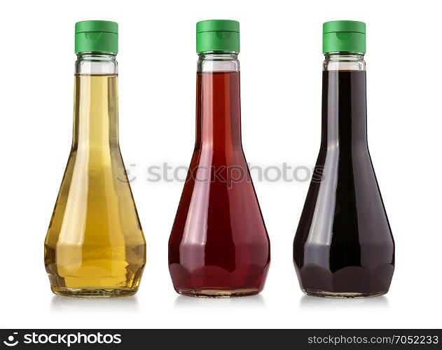 Glass bottles of vinegar isolated on white background