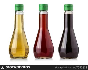 Glass bottles of vinegar isolated on white background