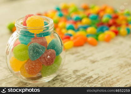 Glass bowl full of colorful jelly beans. Focus in the foreground