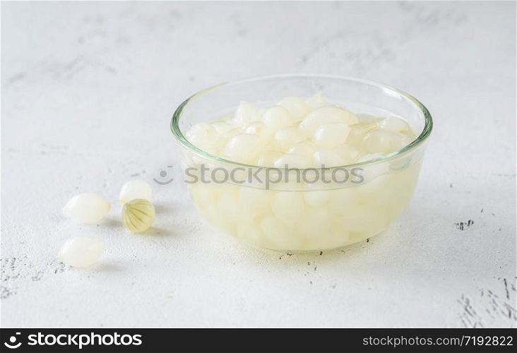 Glass bowl of pickled cipollini onions
