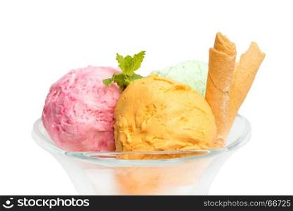 Glass bowl of various colorful ice cream balls with mint leaves and vanilla sticks isolated on white background. From side view.