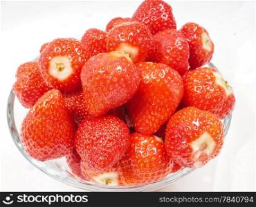 Glass bowl with strawberries isolated towards white