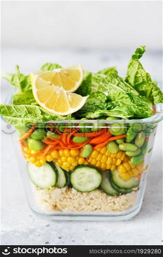 Glass box with fresh raw vegetable salad. Healthy Meal recipe preparation. Healthy vegan dishes in glass container. Vegetarian cuisine. Plant-based dishes. Green living concept. Organic food.