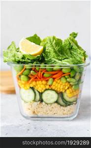 Glass box with fresh raw vegetable salad. Healthy Meal recipe preparation. Healthy vegan dish in glass container. Vegetarian cuisine. Plant-based dishes. Green living concept. Organic natural foods.