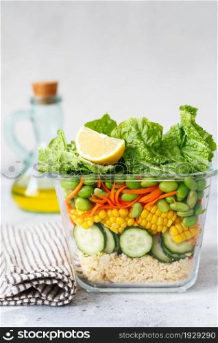 Glass box with fresh raw vegetable salad. Healthy Meal recipe preparation. Healthy vegan dish in glass container. Vegetarian cuisine. Plant-based dishes. Green living concept. Organic natural foods.