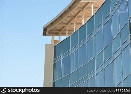 Glass building, all windows, against blue sky