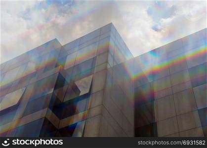 Glass building windows facade motion blur through prism. Abstract spectrum colors reflection.