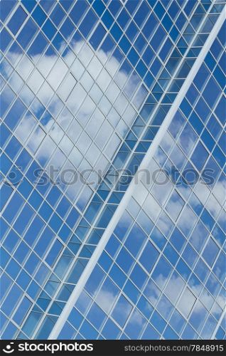 Glass building with cloud reflections