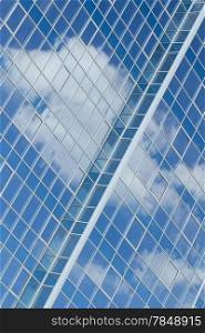 Glass building with cloud reflections