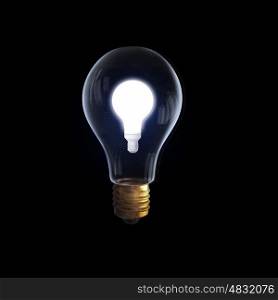 Glass bulb. Glass glowing light bulb on black background