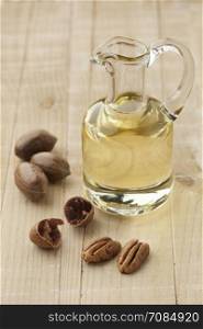 Glass can with pecan oil and nuts