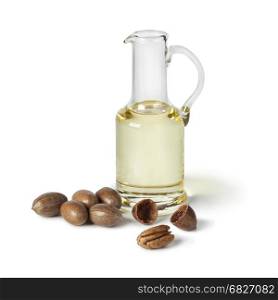 Glass can with pecan oil on white background