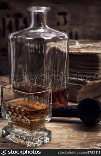 glass carafe with alcoholic drink of whiskey vintage style