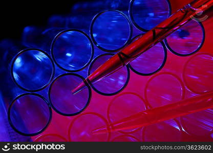 Glass chemistry tubes on a colour background