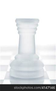 glass chess rook is standing on board, cut out from white background