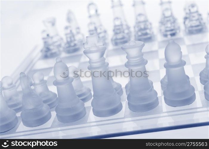 Glass chess. The first move. Blue toned.