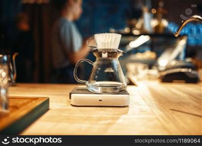 Glass coffee pot stands on stove closeup, nobody. Aroma espresso preparation, barista occupation. Glass coffee pot stands on stove closeup, nobody