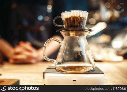 Glass coffee pot stands on stove closeup, nobody. Aroma espresso preparation, barista occupation. Glass coffee pot stands on stove closeup, nobody